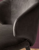 Dark chocolate velvet bar stool with curved backrest and piping detail, side view angle.