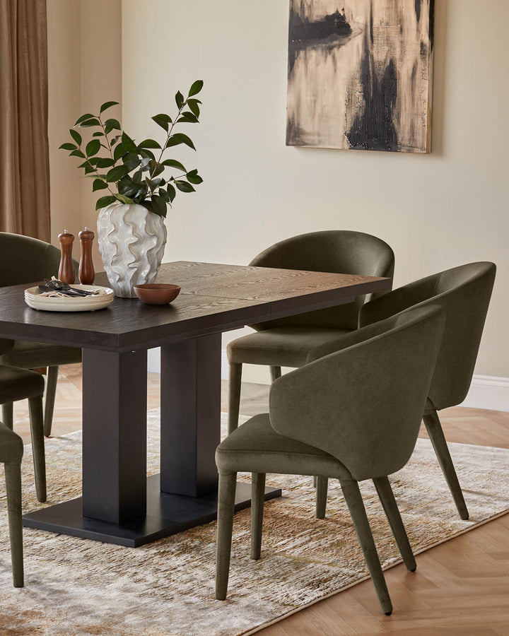 A dining table with dark wood top and base, surrounded by four upholstered chairs in a neutral tone.