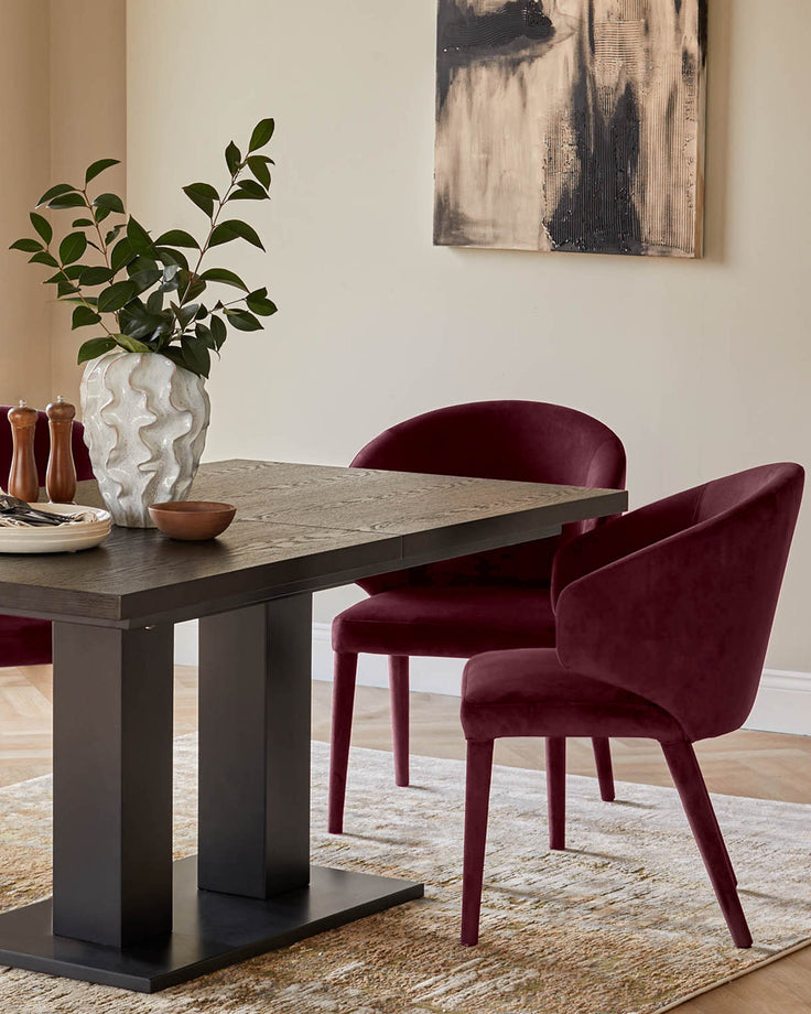 Ethan dining chair in plum velvet, shown in a styled dining room setting at a dark wood table.