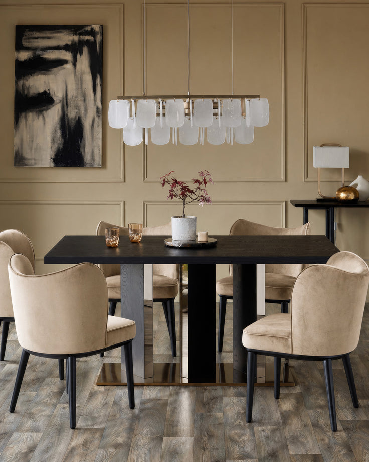 Evelyn dining chair in champagne velvet with black wooden legs, shown in a modern dining room setting.