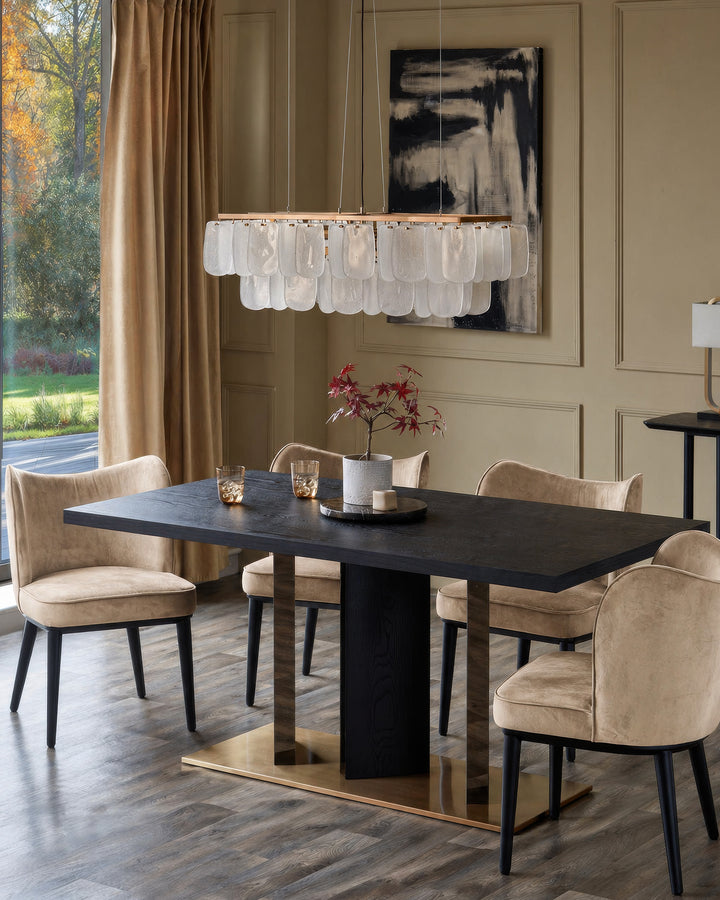 Evelyn dining chair in blackwood and champagne velvet, shown in elegant dining room setting with black table.