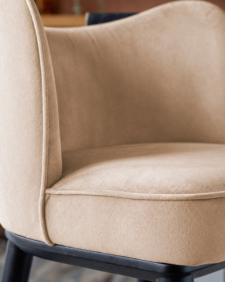 Evelyn bar stool in champagne velvet with black wood base, close-up of seat and backrest detail.