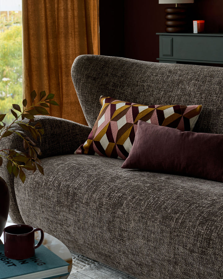 Evelyn 3-seater sofa in mocha fabric, displayed in a styled living room with decorative pillows and greenery.