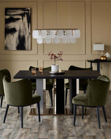 A sophisticated dining set with an oak table, stylish green velvet chairs and a modern chandelier.
