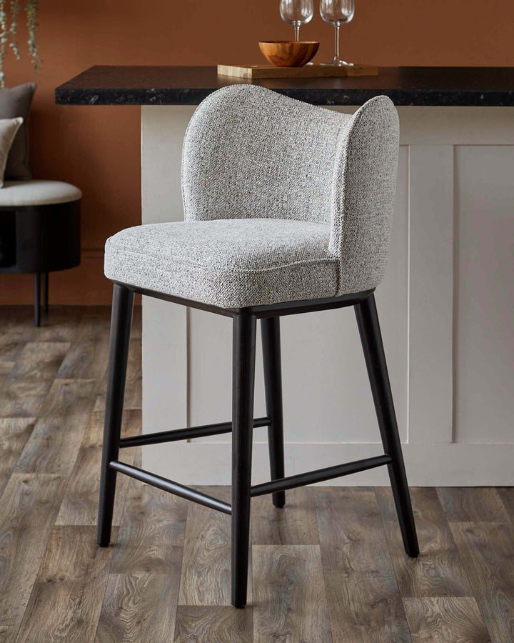Upholstered bar stool with dark wood frame. Perfect for adding a touch of elegance to your kitchen or bar area.
