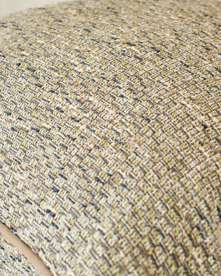 Close-up of Fabian large green cushion showing textured woven fabric with neutral and blue-toned yarns in a basket weave pattern.