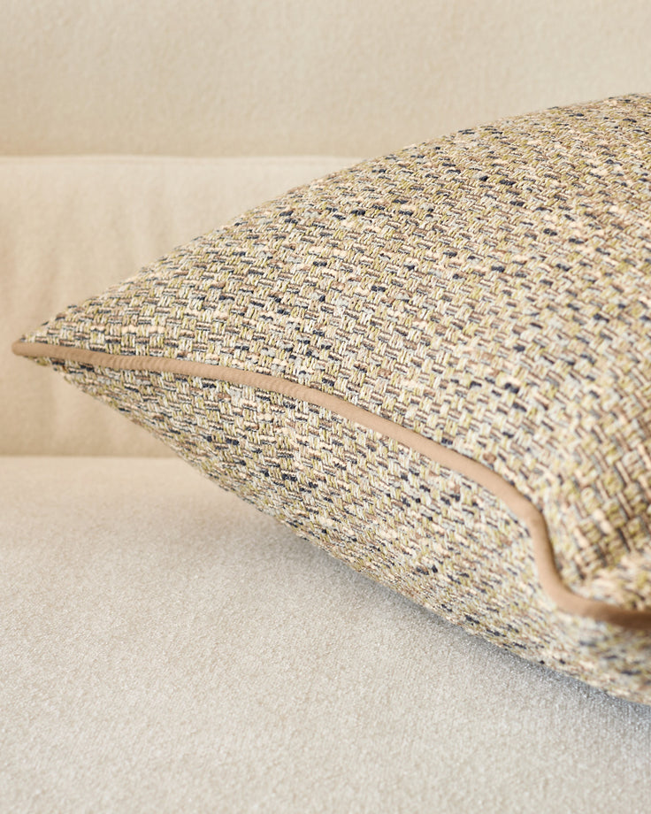 Fabian cushion in large size with green-toned woven texture, displayed at an angle showing its plump form and woven fabric detail.