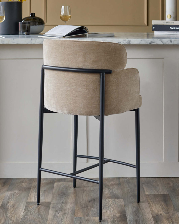 A stylish bar stool with a cushioned seat and sleek black frame. Perfect for modern kitchens and dining areas.