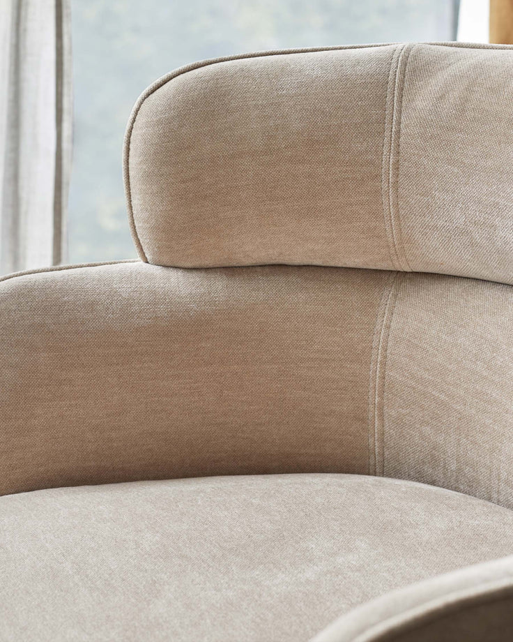 Close-up of a stylish, neutral-toned armchair showcasing its textured fabric and curved design. A comfortable seating option.
