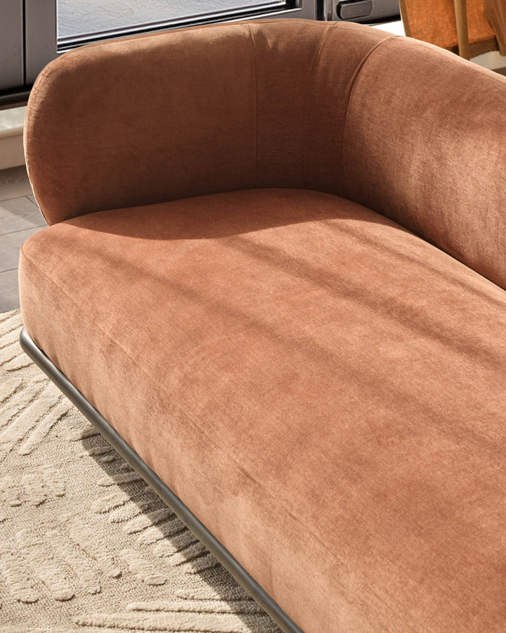 Florence 2-seater sofa in apricot fabric with curved arms and dark wood base, angled view.