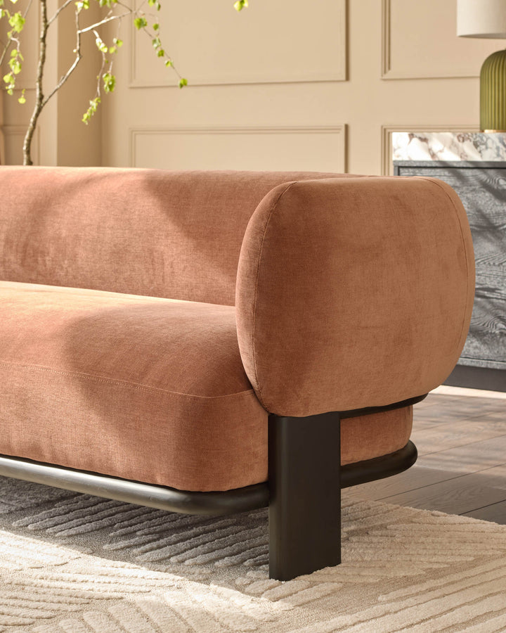 Florence right-hand corner sofa in apricot fabric with dark wood legs, shown from side angle in styled living room setting.