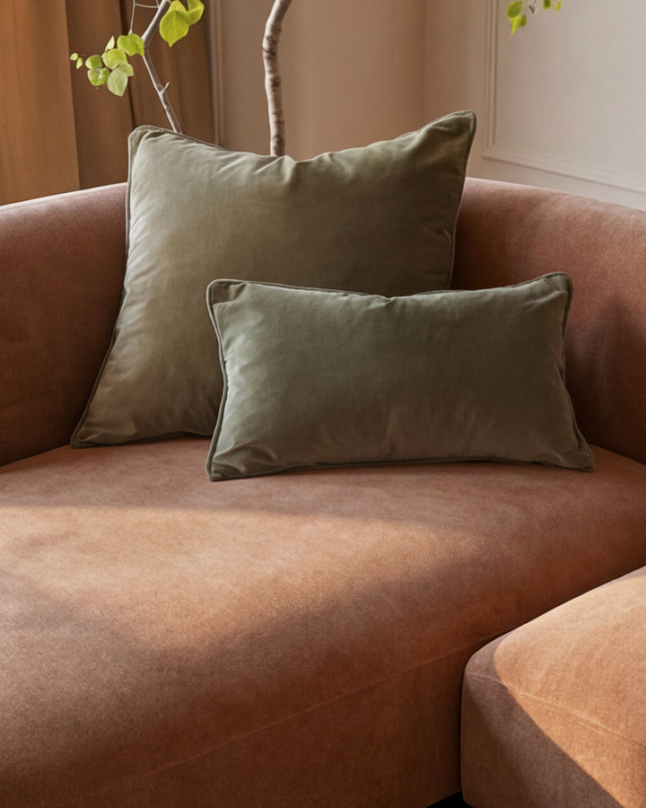 Florence right-hand facing chaise sofa in apricot fabric with sage green piping pillows and decorative branch styling.
