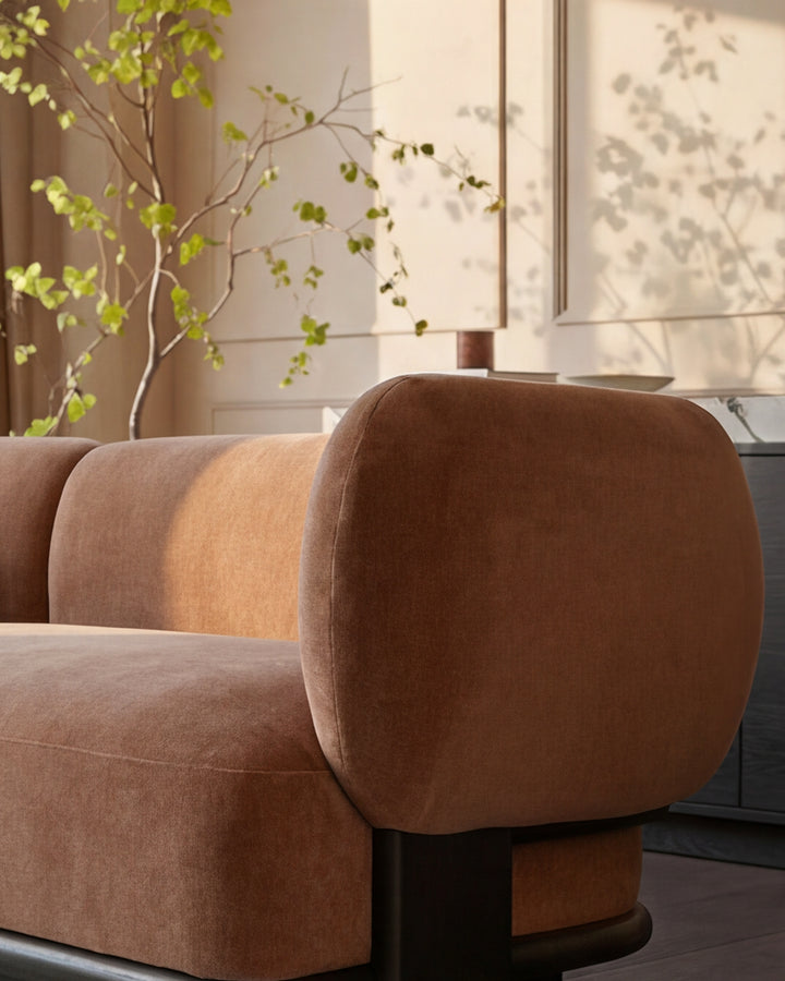 Florence left-hand corner sofa in apricot fabric with rounded arms and dark wood legs, positioned in bright room with plants.