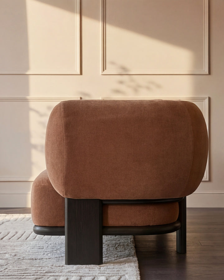 Florence left-hand chaise lounge in apricot fabric with dark wood base, shown from rear angle in bright sunlit room.