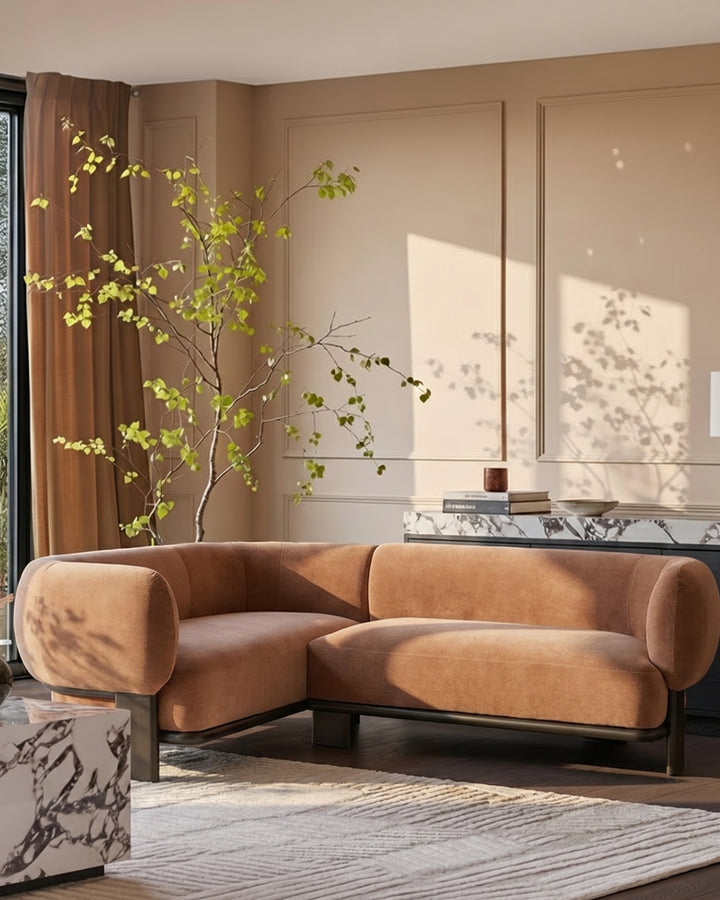 Florence left-hand corner sofa in apricot fabric with dark wood legs, positioned in a warm-toned living room setting.
