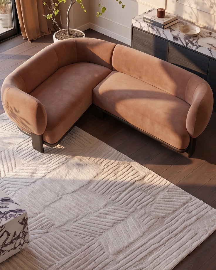 Florence left-hand-facing small corner sofa in apricot fabric with dark wood legs, displayed in a modern living room setting.