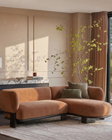 Florence right-hand-facing chaise sofa in apricot fabric with dark wood base, displayed in a modern living room setting.