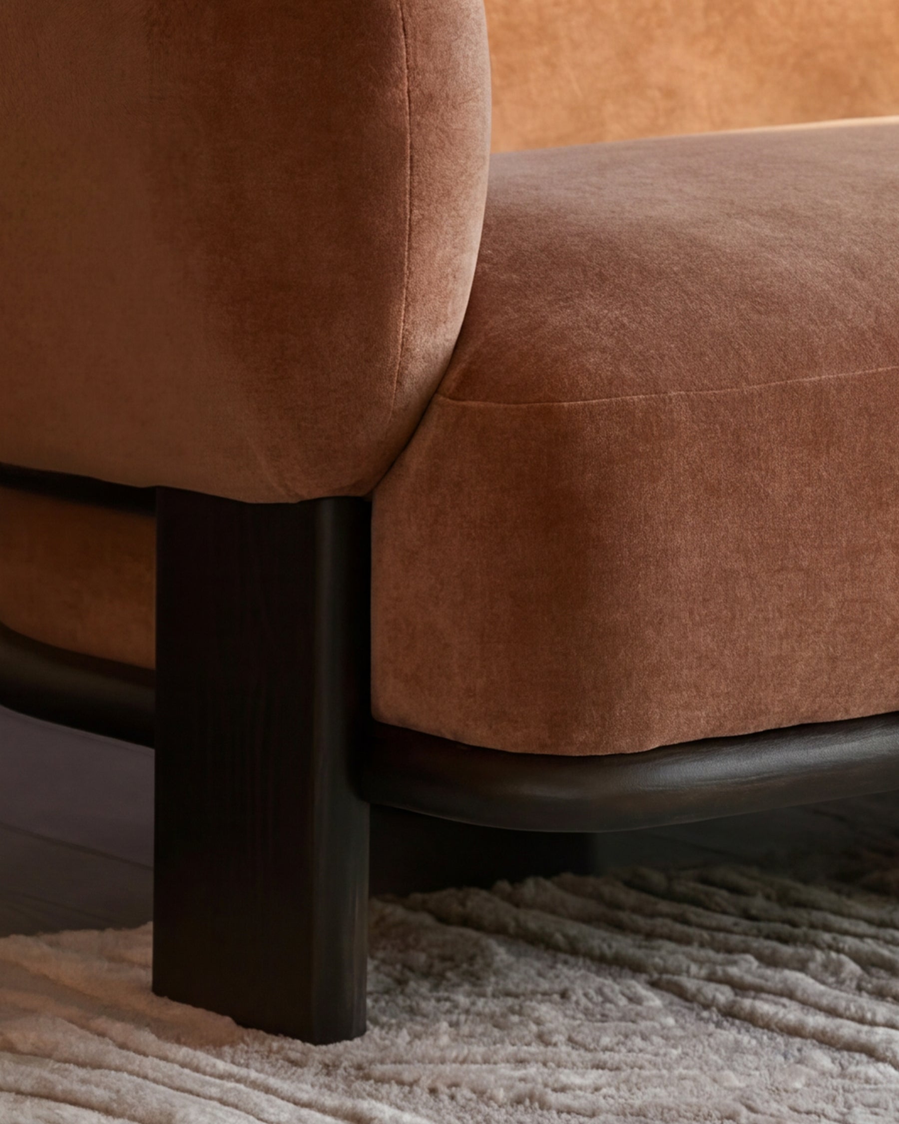 Florence right-hand corner sofa in apricot fabric with dark wood legs, shown from side angle on neutral rug.