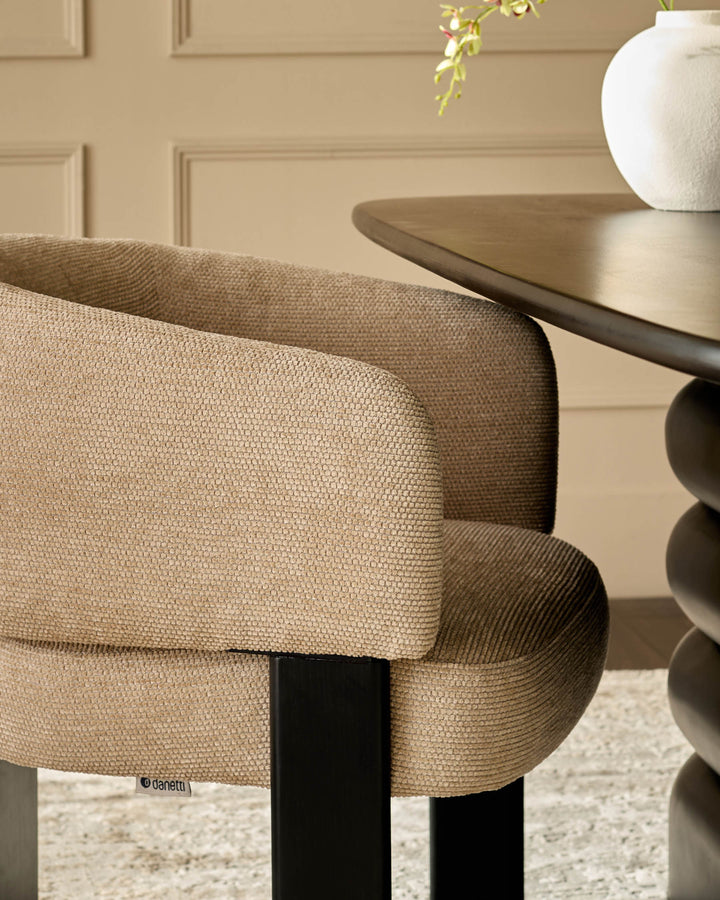Florence dining chair in honey fabric, showing curved backrest and black wooden legs from a side angle.