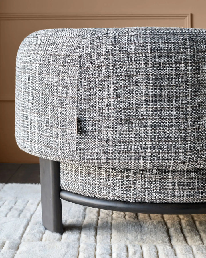 Florence armchair in dark chocolate weave fabric with dark wood legs, shown from side angle on striped rug.