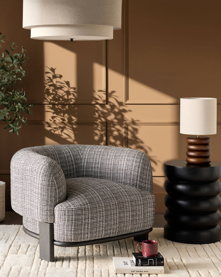 Florence armchair in dark chocolate weave fabric with dark wood base, displayed in a styled living room setting.