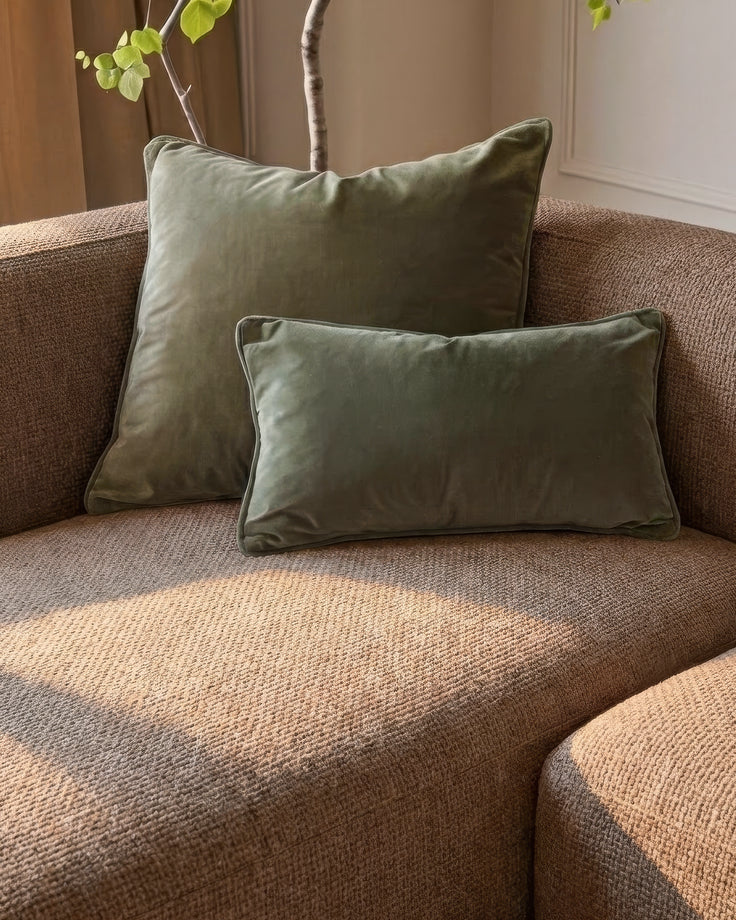 Florence left-hand chaise sofa in mocha fabric with sage green velvet pillows and decorative branch styling.