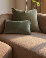 Florence right-hand chaise sofa in mocha fabric with sage green velvet pillows and decorative branch with foliage.