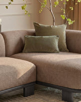 Florence right-hand-facing chaise sofa in mocha fabric with dark wood base, styled with sage green pillows and decorative branches.