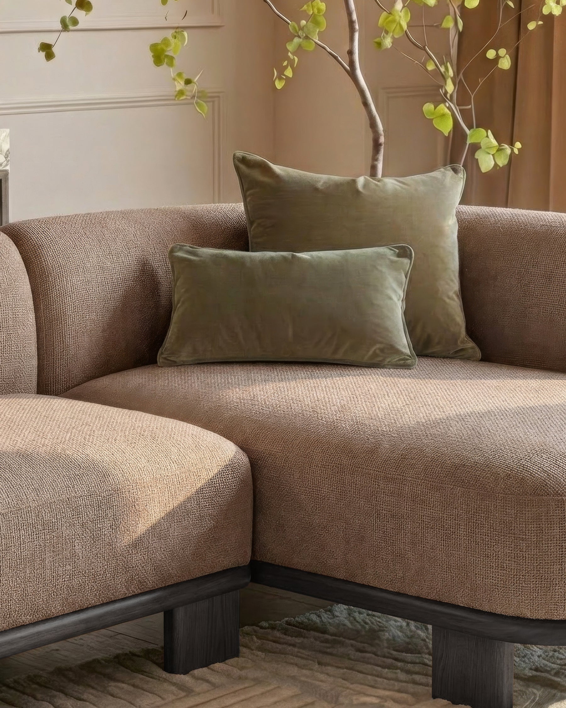Florence right-hand-facing chaise sofa in mocha fabric with dark wood base, styled with sage green pillows and decorative branches.