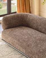 Florence 2-seater sofa in mocha fabric with curved backrest and metal base, shown at an angle in a bright room with windows.