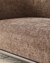 Close-up of mocha fabric texture on Florence 2-seater sofa arm with metal frame detail visible.