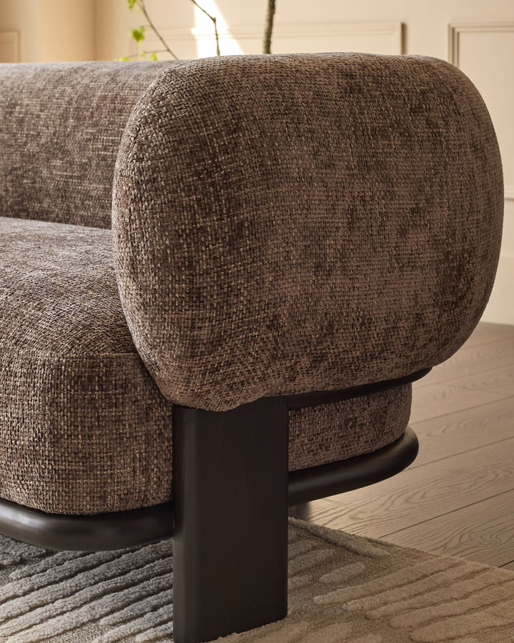 Florence 2-seater sofa in mocha fabric with curved armrest and dark wood base, side view detail.