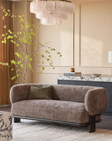 Florence 2-seater sofa in mocha fabric with dark wood frame, curved arms, displayed in a styled living room setting.