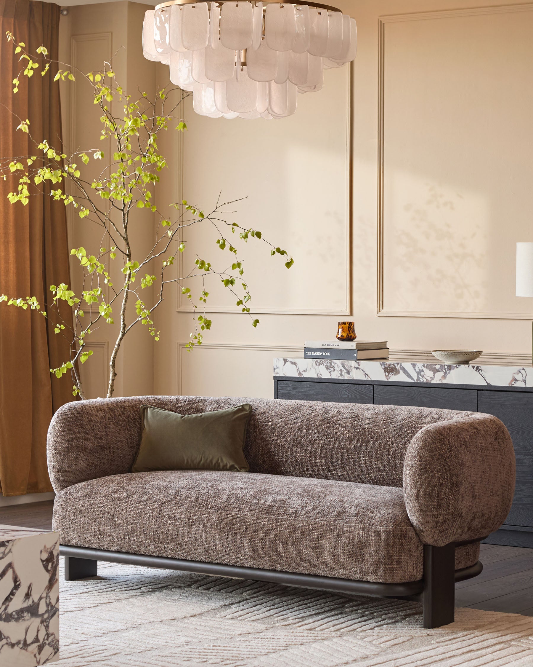 Florence 2-seater sofa in mocha fabric with dark wood frame, curved arms, displayed in a styled living room setting.