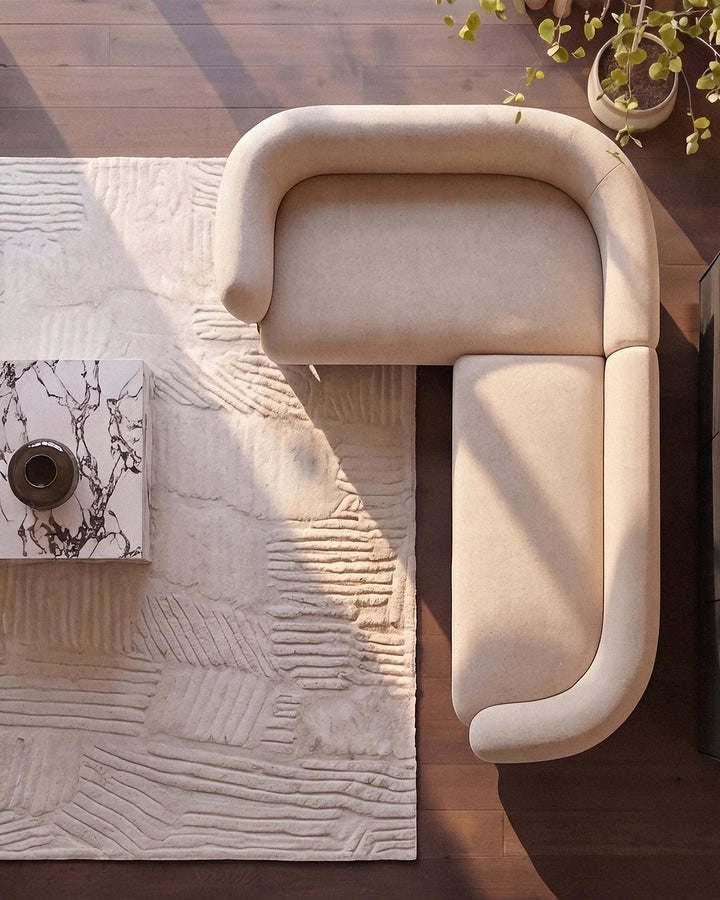 Florence left-hand-facing small corner sofa in natural fabric, viewed from above on wooden floor with plants.