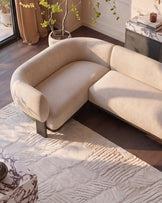 Florence left-hand-facing small corner sofa in natural fabric with dark wood legs, shown in a bright living room setting.