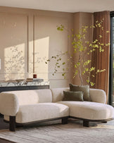 Florence right-hand-facing chaise sofa in natural fabric with dark wood legs, displayed in a styled living room setting.