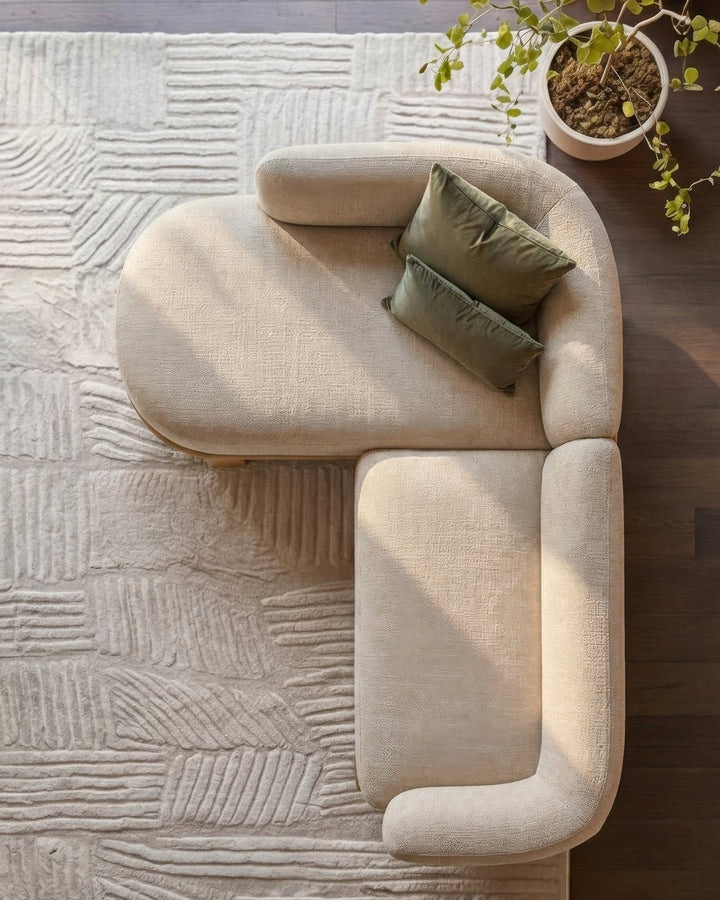 Florence left-hand facing chaise sofa in natural light fabric, shown from above with green pillows and potted plant.