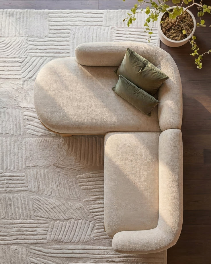Florence left-hand facing chaise sofa in natural light fabric, shown from above with green pillows and potted plant.