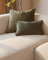 Florence left-hand chaise sofa in natural fabric with olive green pillows and dark wood legs, angled view.