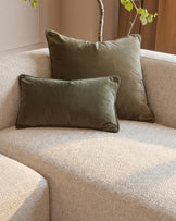 Florence right-hand chaise sofa in natural fabric with sage green piped pillows and decorative branches.