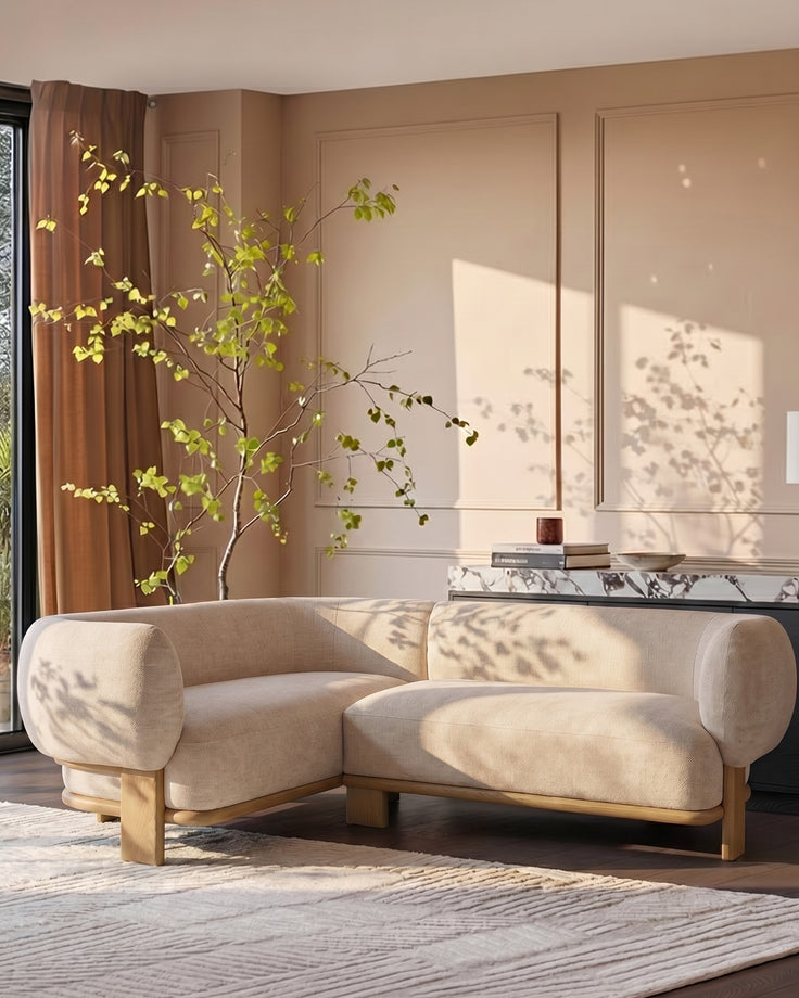 Florence left-hand-facing small corner sofa in natural fabric with light wood legs, displayed in a bright living room setting.