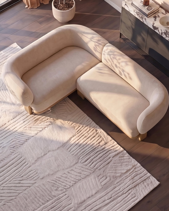 Florence left-hand-facing small corner sofa in natural fabric with light wood legs, shown in a bright living room setting.