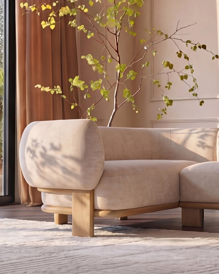 Florence left-hand-facing small corner sofa in natural fabric with light wood legs, positioned in a bright room with decorative branches.