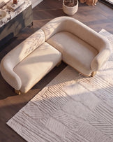 Florence right-hand-facing small corner sofa in natural fabric with light wood legs, shown in bright sunlight.