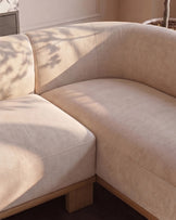 Florence right-hand-facing small corner sofa in natural fabric with light wood legs, angled view showing curved seating.
