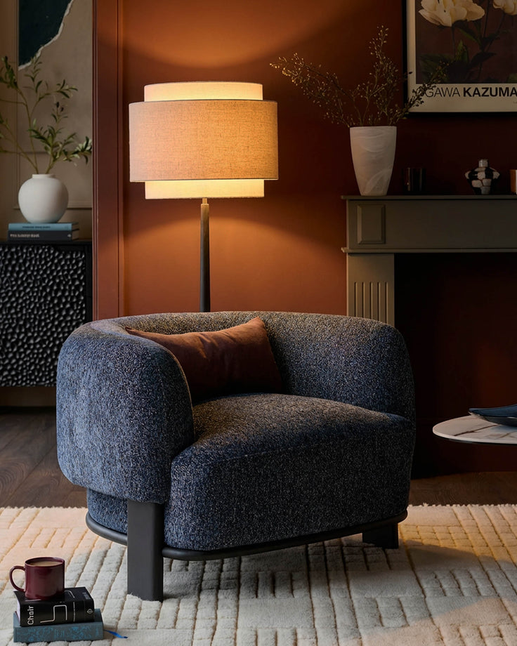 Florence armchair in navy weave fabric with dark wood legs, shown in a styled living room setting.