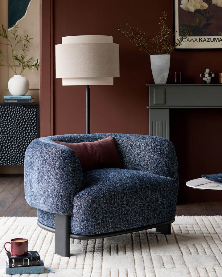 Florence armchair in navy weave fabric with dark wood legs, displayed in a styled living room setting.