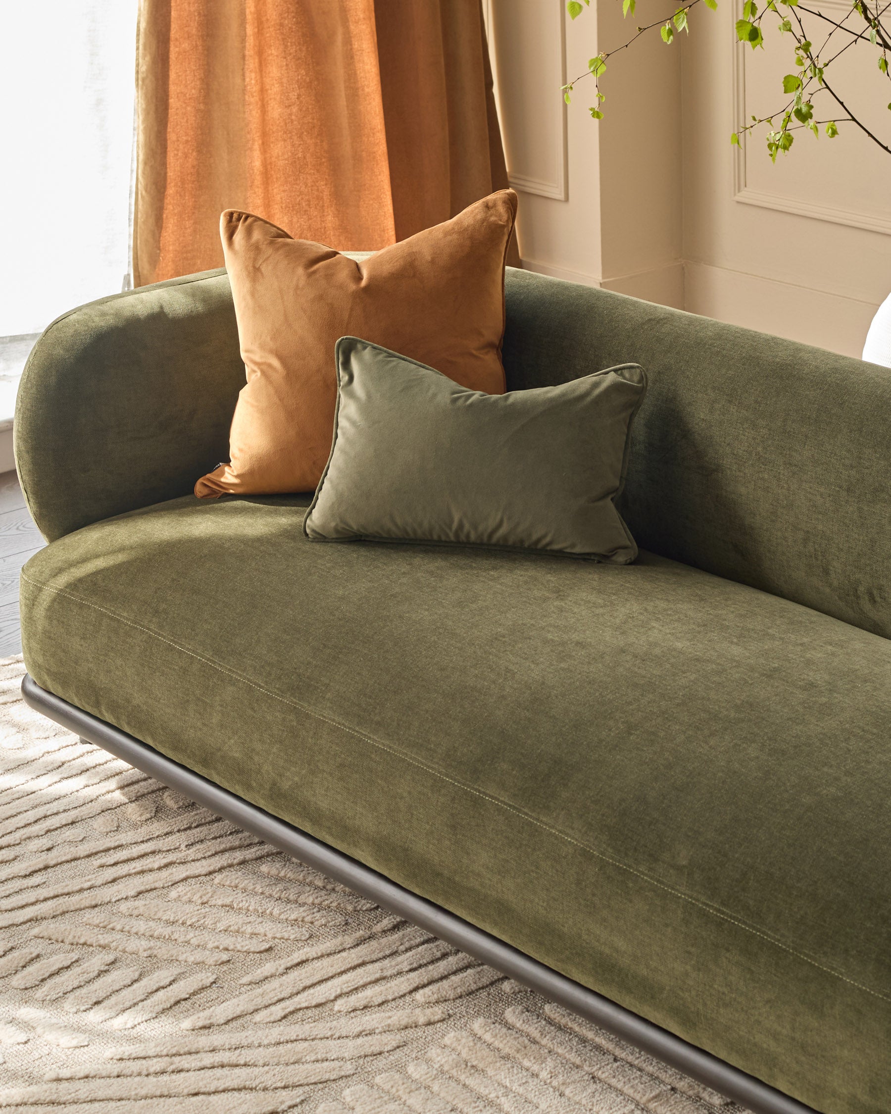 Florence 3-seater sofa in olive green fabric with rounded arms, paired with tan and sage green cushions in a bright room.