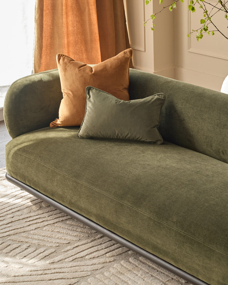 Florence 3-seater sofa in olive green fabric with rounded arms, paired with tan and sage green cushions in a bright room.